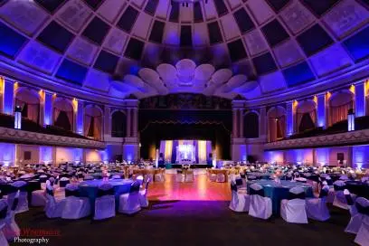 Lavishly lit South Asian wedding reception hall with purple uplighting and elegant decor in Atlanta